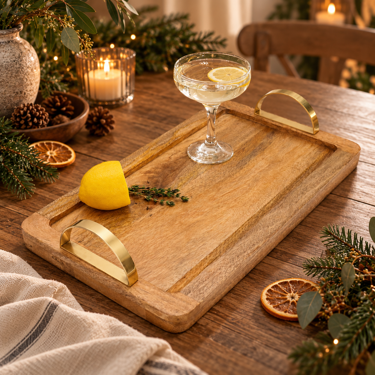 natural wood tray on a festive table with a cocktail ready to serve, candlelight in the background
