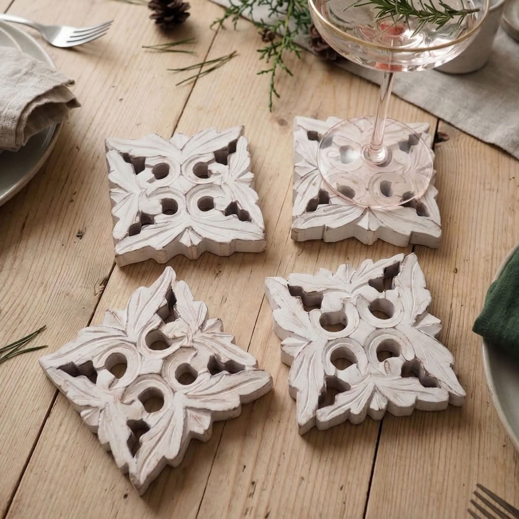 white wooden drink coasters on a natural wood table with green foliage and linens
