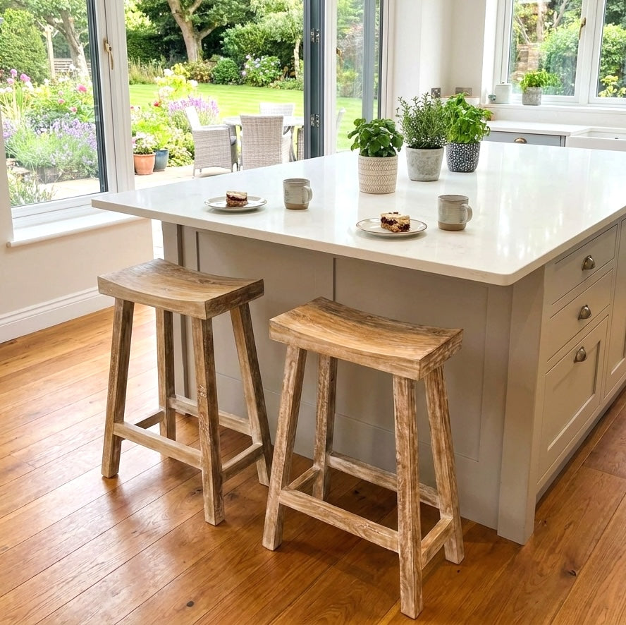kitchen with wooden floors, kitchen island and wooden breakfast bar stools