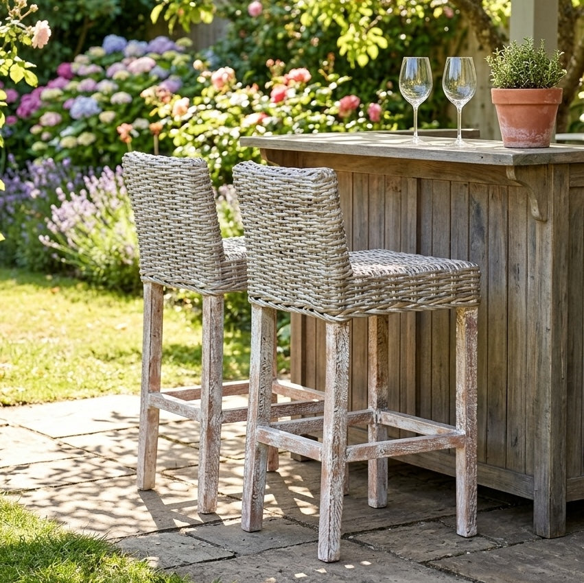 garden patio with outdoor kitchen and wicker bar stools with drinks