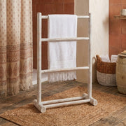 white wooden bathroom towel rail freestanding in boho style bathroom with moroccan curtain