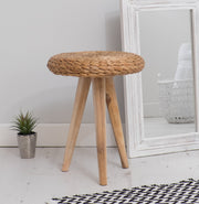 wicker foot stool with mirror and plant