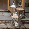 Three large floor lanterns outside on steps at wedding venue