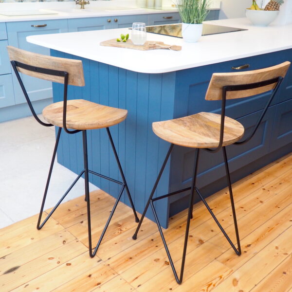 Wooden bar stools with backrest by blue kitchen island