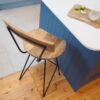 Metal bar stool with backrest by kitchen island