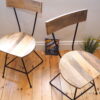 two industrial dining chairs on wooden floor by book