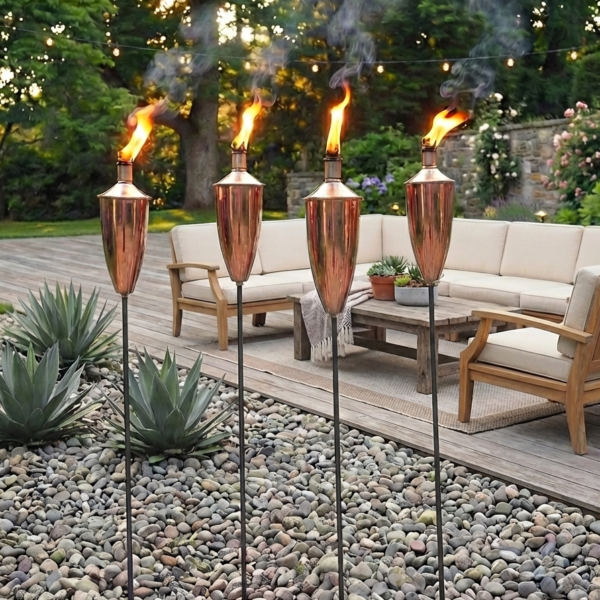 copper garden torches on patio with garden sofa