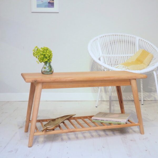 Wooden coffee table on wooden floor with white chair