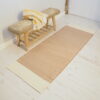 Natural hallway runner in cotton on white floor with seagrass bench behind