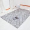 Grey carpet rug geometric on white floor in front of white curtains