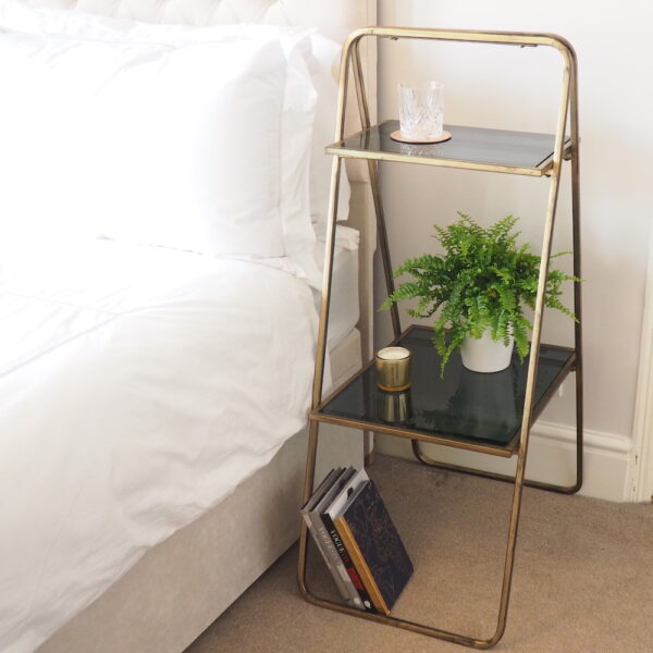 Elegant Brass Shelving Unit next to Bed