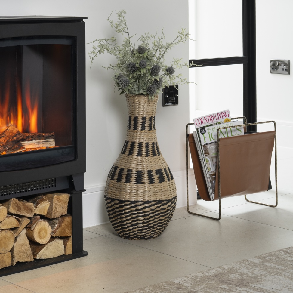 fireplace with wicker vase and magazine rack in living room