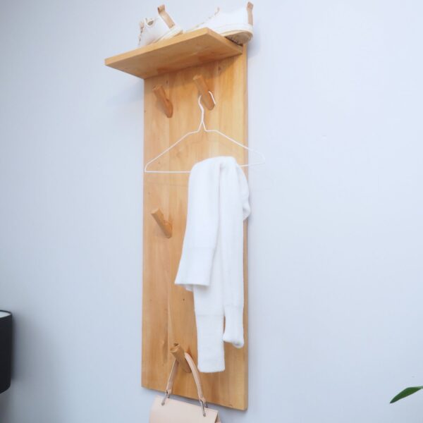 Coat hooks with shelf. Wall mounted clothes rack on white wall