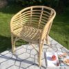 bamboo garden chair outside on grey rug with book