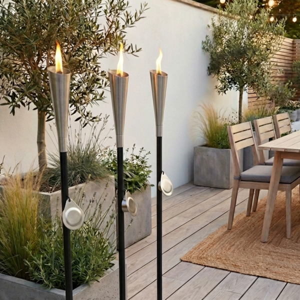 garden patio with oil lamps burning, dining table in background