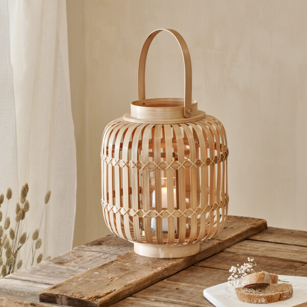 Natural Bamboo Hurricane Lantern on wooden table with marble chopping board