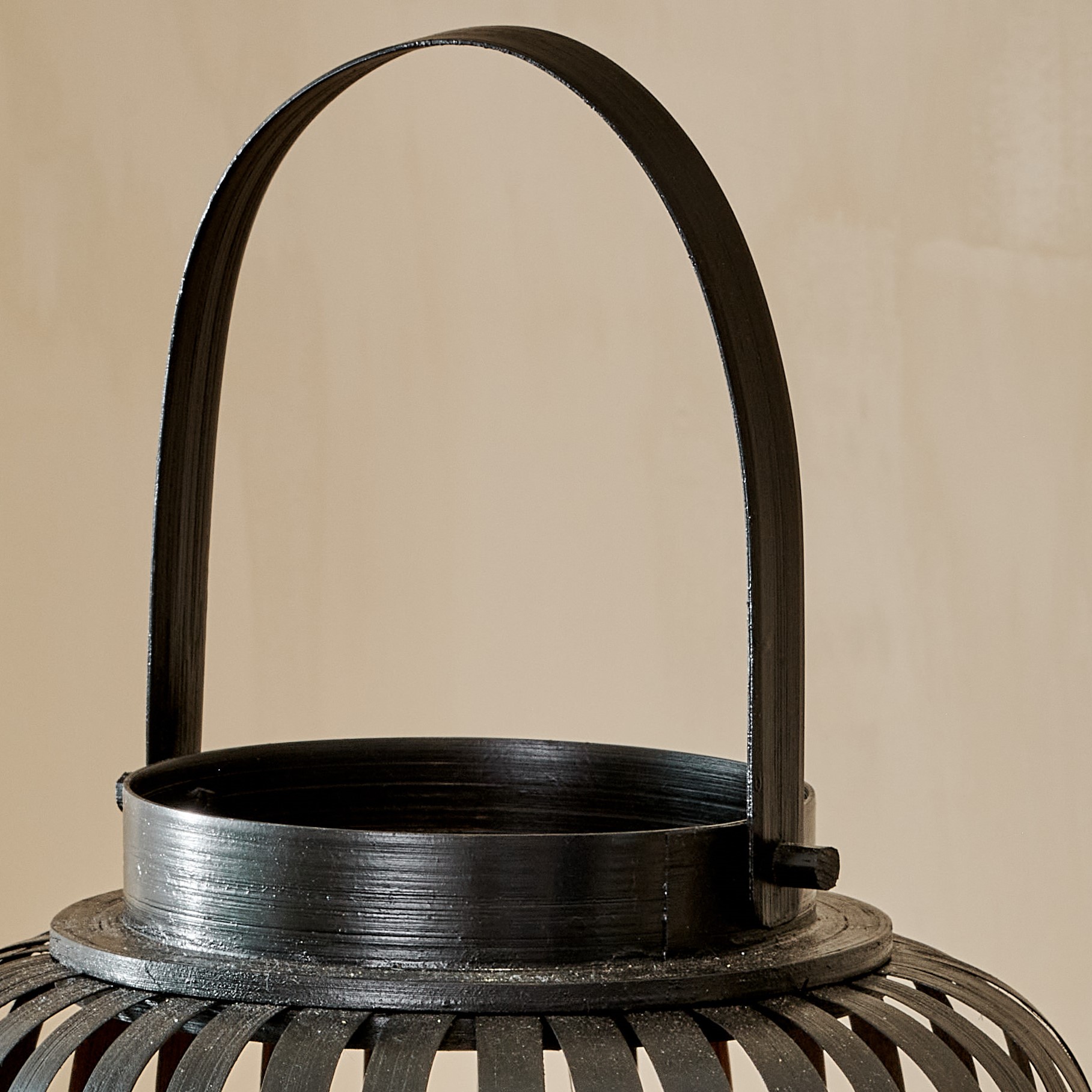 Close up of handle of black bamboo lantern