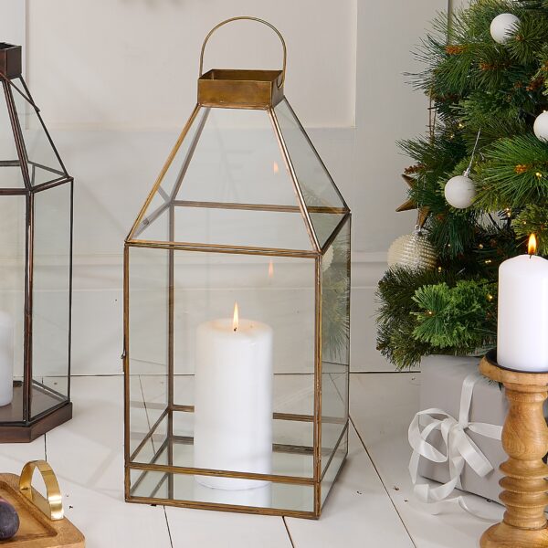 brass candle lantern in christmas setting with Christmas tree