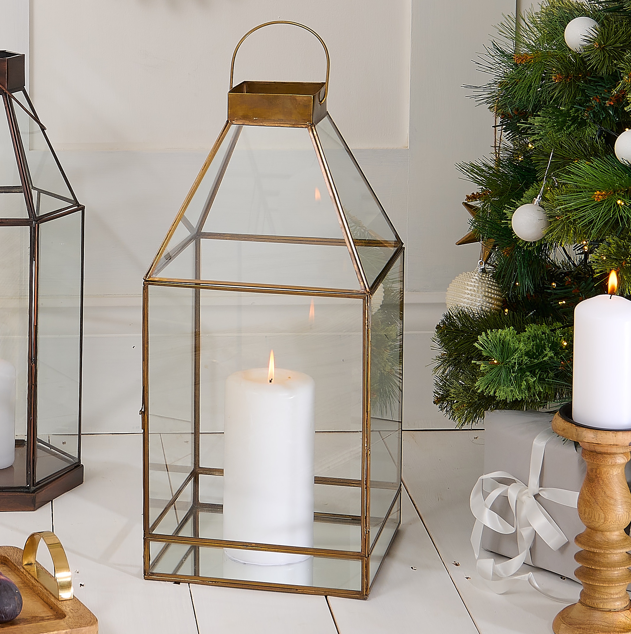 brass candle lantern in christmas setting with Christmas tree