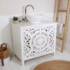white bathroom vanity unit with bamboo towel ladder and jute rug