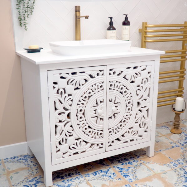 White freestanding vanity unit in bathroom with sink and tap