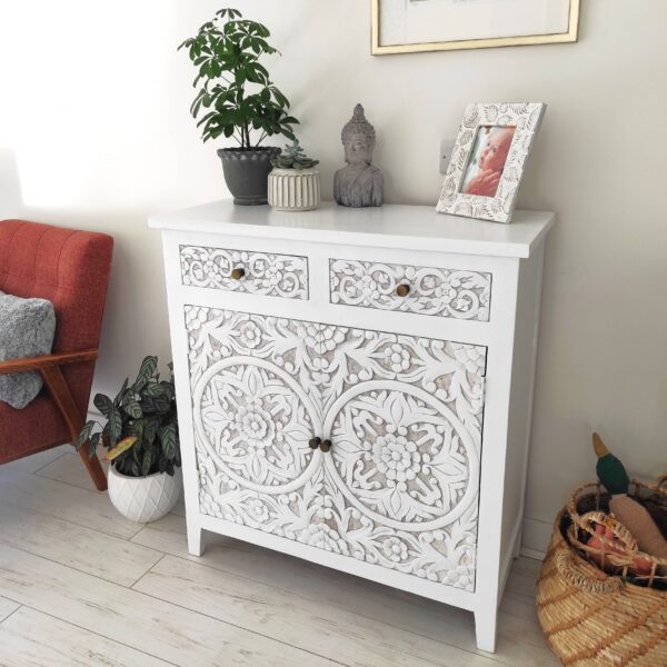 Carved Wood Sideboard on wooden floor with potted plants and red chair