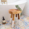 small rustic wooden stool in bathroom by bath