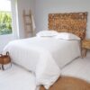 Carved Wooden Headboard with White Bed