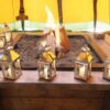 Small silver tealight lanterns by firepit in tent