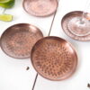 Copper drinks coaster on white table