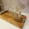 wooden tray with metal handles and glass jugs