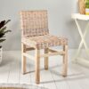 rattan dining chair on white floor with table