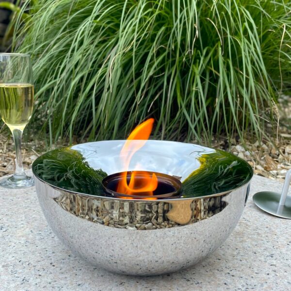 Silver outdoor gel lamp in garden with drink and nature