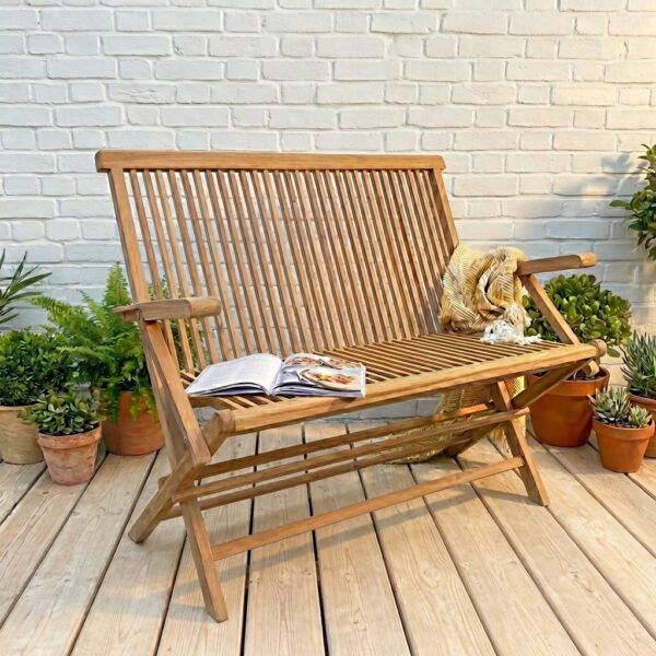 teak wood folding garden bench on patio with plants