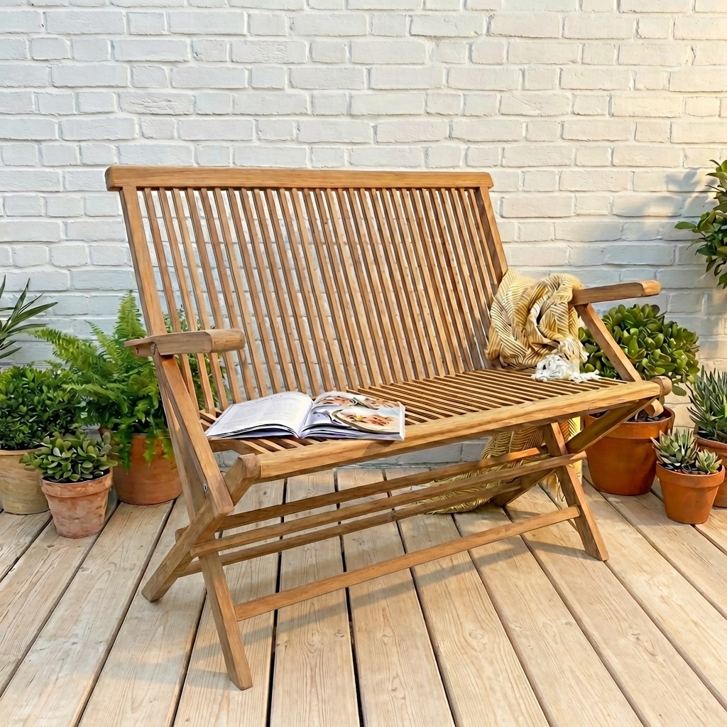 teak wood folding garden bench on patio with plants