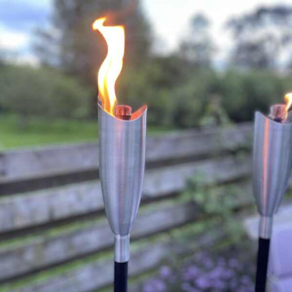 garden tiki torch on patio with flame