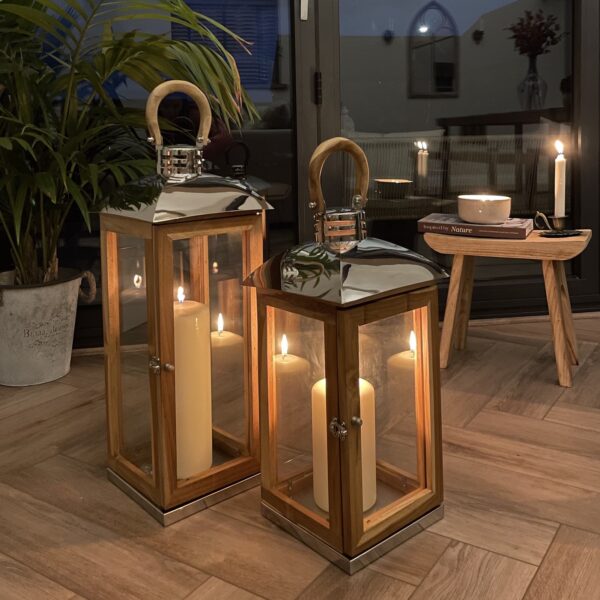 two wooden lanterns in cosy room with candles