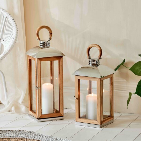 Mango wood and stainless steel candle lantern on white wooden floor
