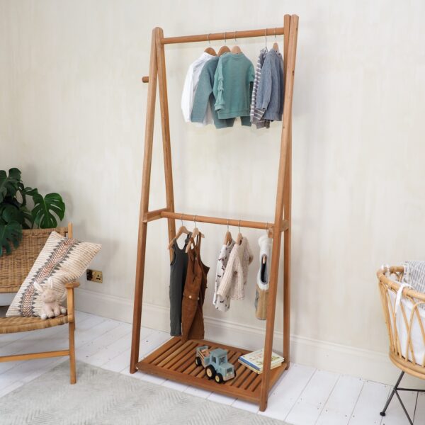 children's clothes rail in bedroom with arm chair and rug