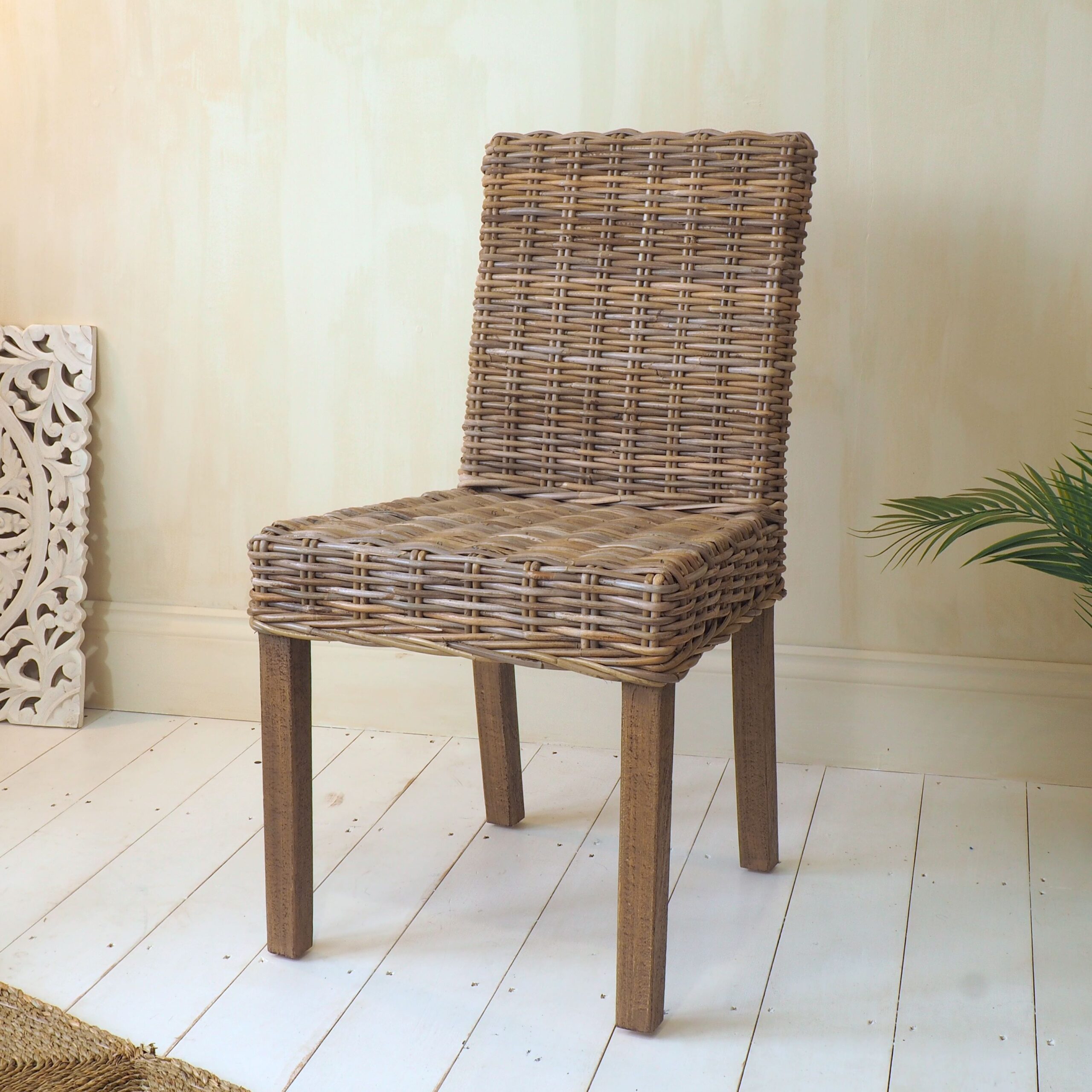 Wood and wicker natural dining chair on white wooden floor
