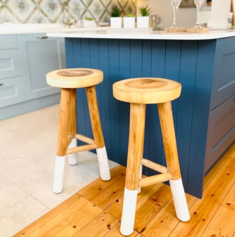 Rustic wood kitchen stools under blue kitchen island