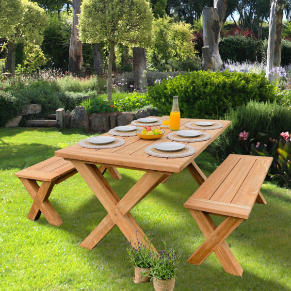 Wooden garden table and benches in sunny garden on lawn