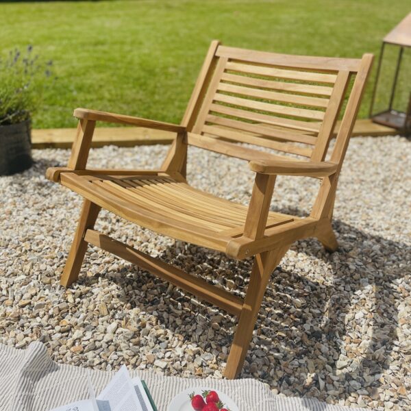 wooden sun chair in garden with rug