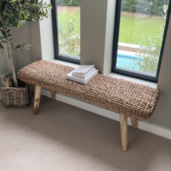 wicker bench in hallway with olive tree
