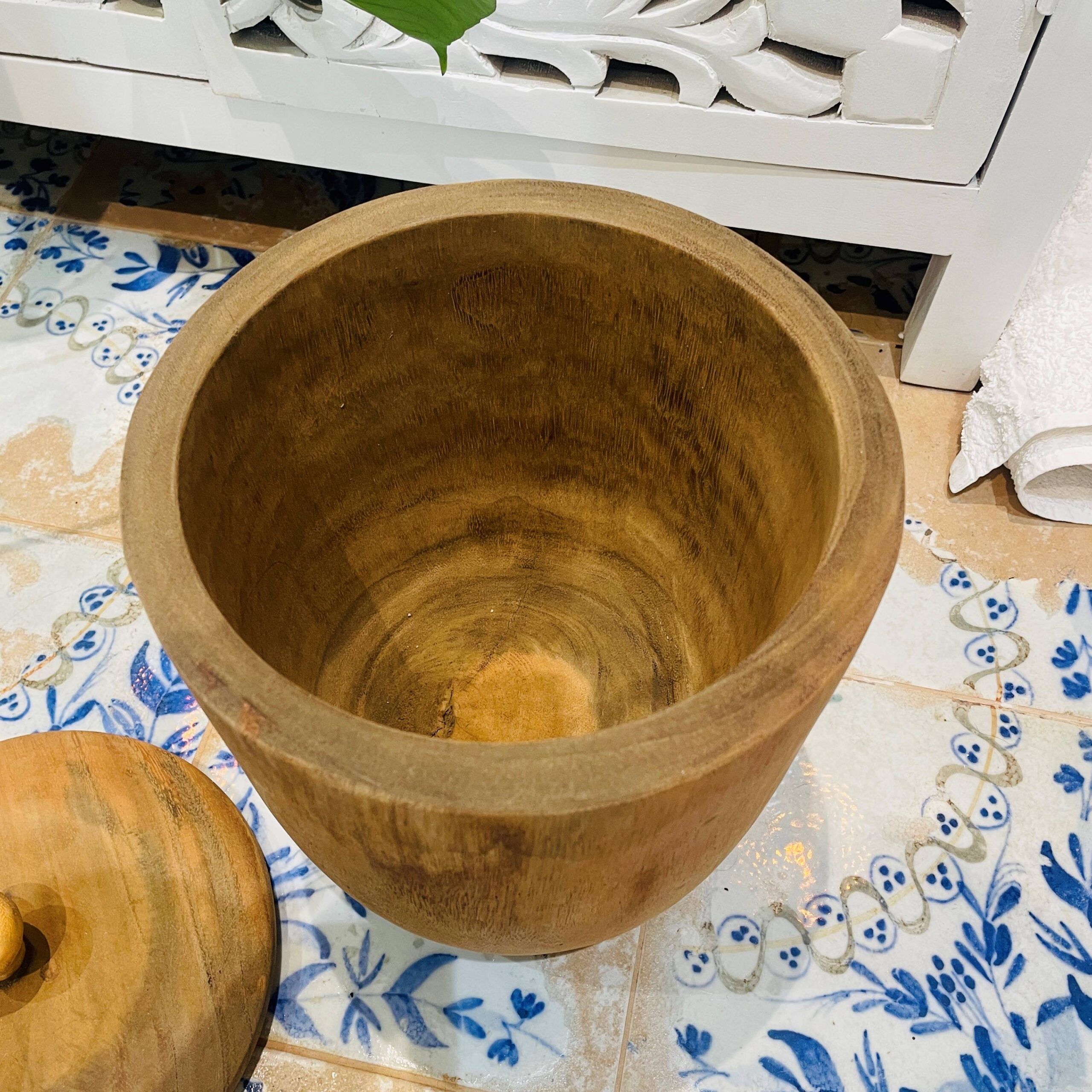 Wooden pot on tiled floor in bathroom