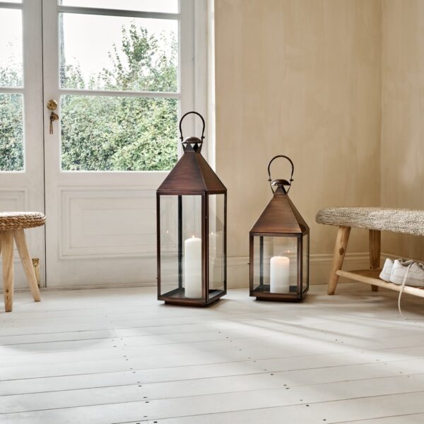 Aged Coper Lantern with provence bench and black plant stand.