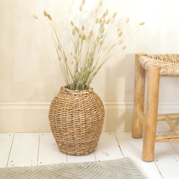 Wicker vase with flowers in hallway