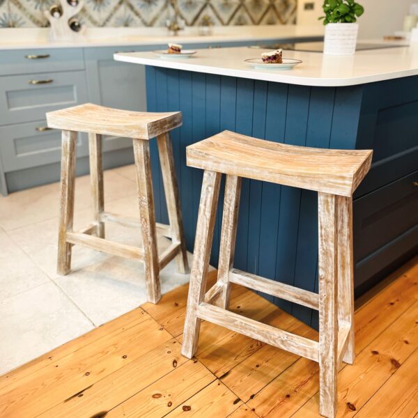 Whitewashed bar stool on wooden floor in kitchen