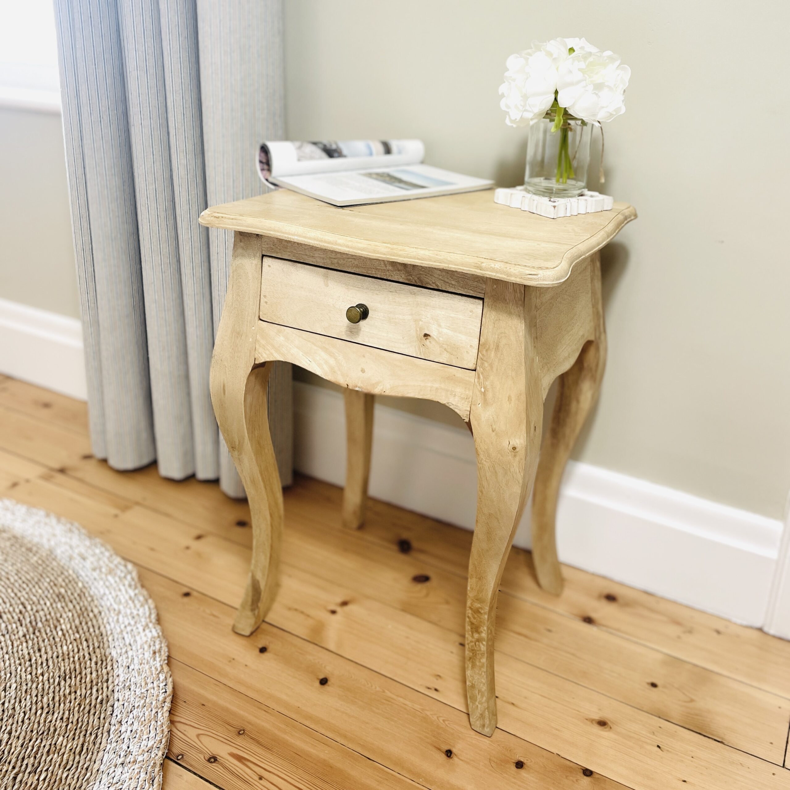 Natural Bedside Table on wooden floor in bedroom setting