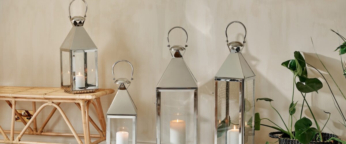 Silver Topsham Lanterns on wooden floor with plant and trainers